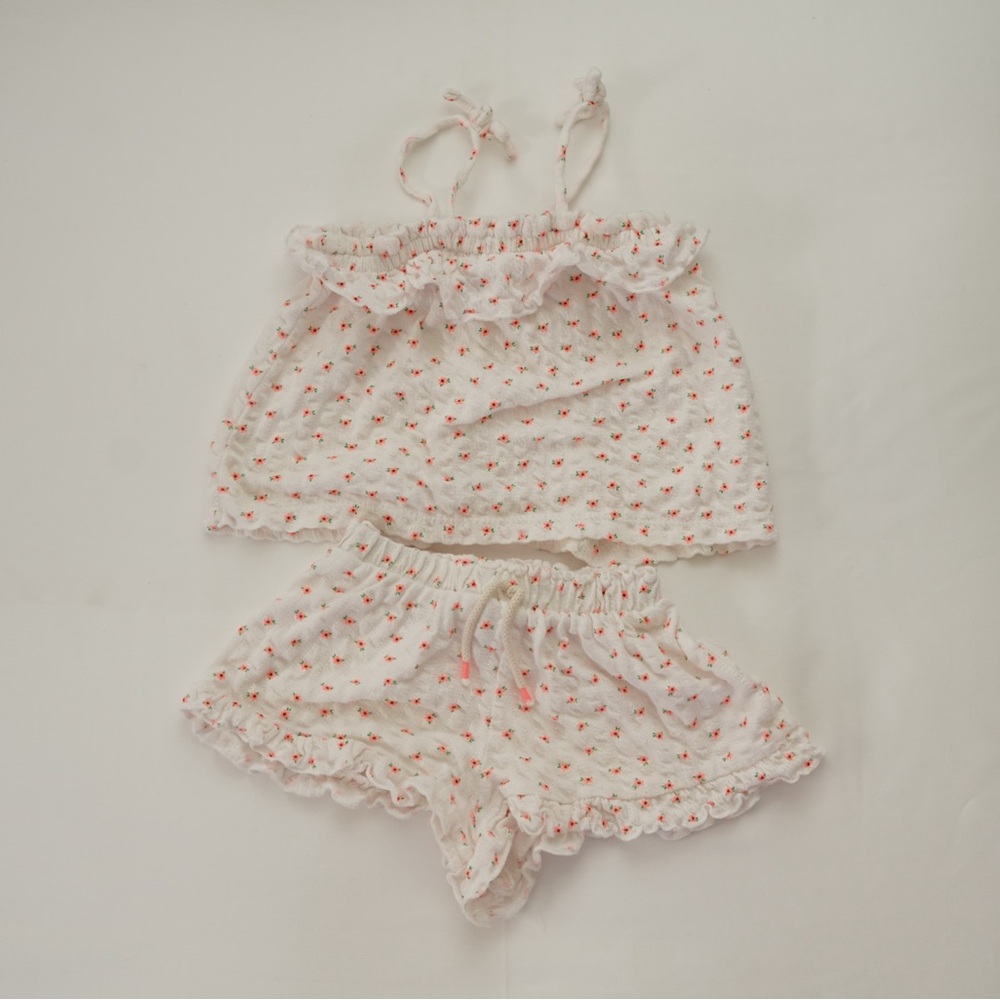 Zara white gauze tank with orange flowers and ruffle details.